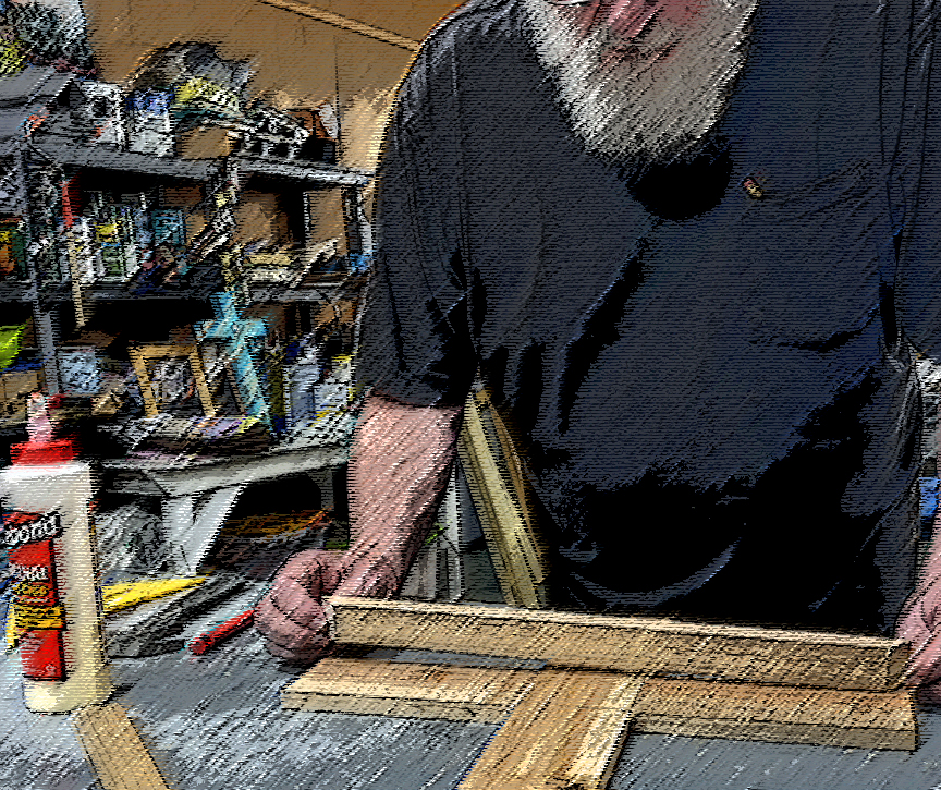 Artisan assembling a wooden cross at his workbench in the studio